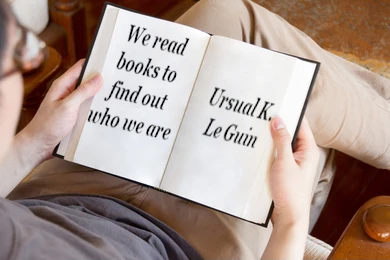 Book with Ursla K Le Guin Quote We read books to find out who we are